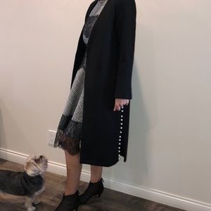 Black coat with faux pearl buttons.